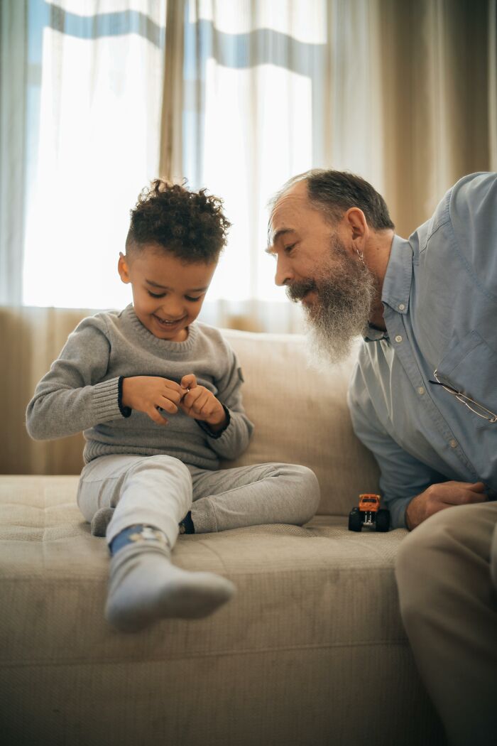 Grandfather and grandson sharing joyful moment indoors