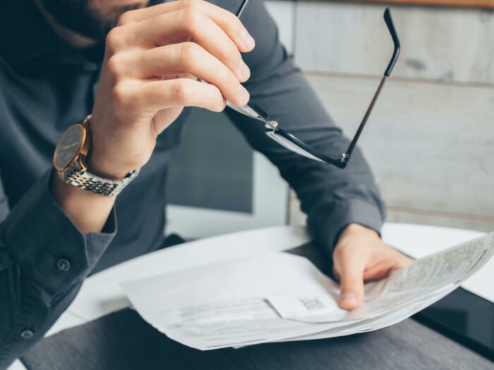 Man reading legal documents showing pro revenge after job loss Man reading legal documents showing pro revenge after job loss