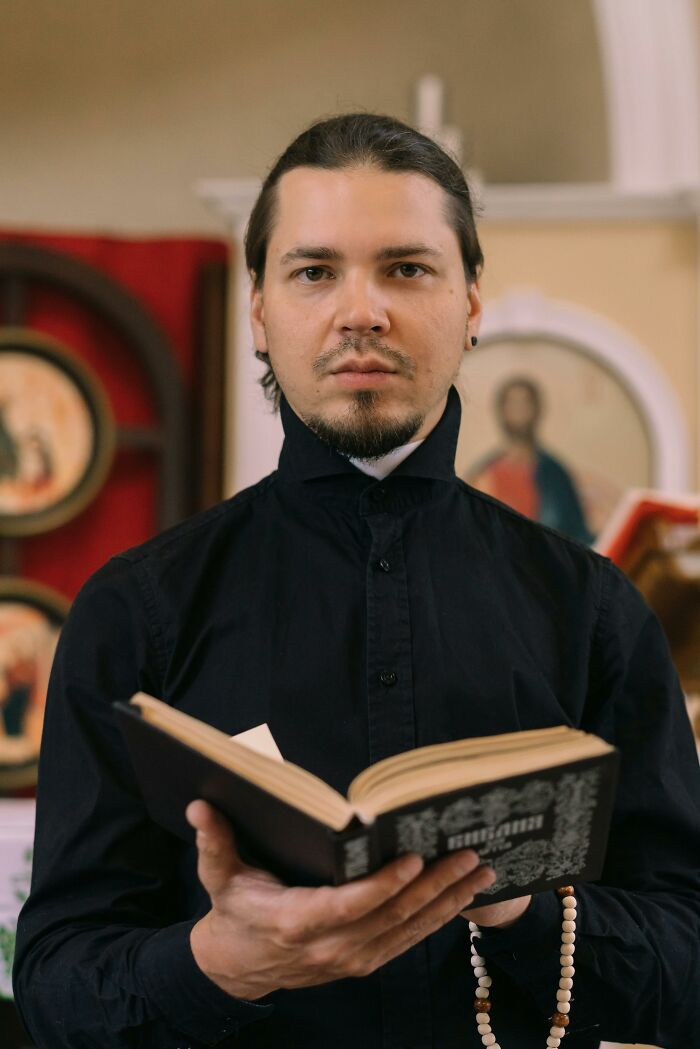 Cult leader holding a religious book in a church