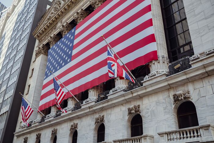 Large American and British flags displayed on building representing American vs British words quiz Large American and British flags displayed on building representing American vs British words quiz