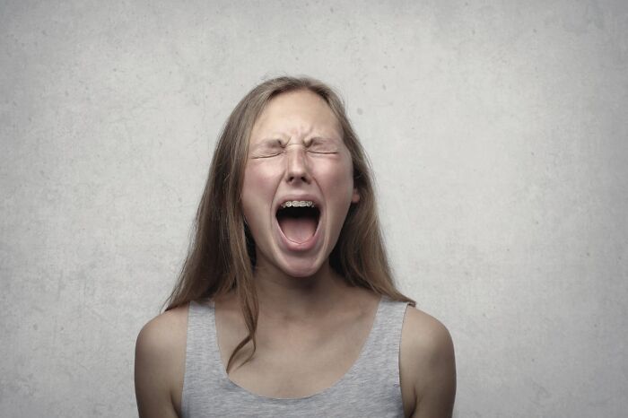 A young woman screaming in frustration, embodying wedding drama.