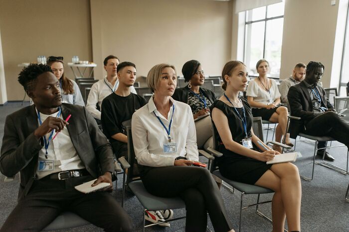 Diverse group of people attending a seminar or meeting related to cult awareness
