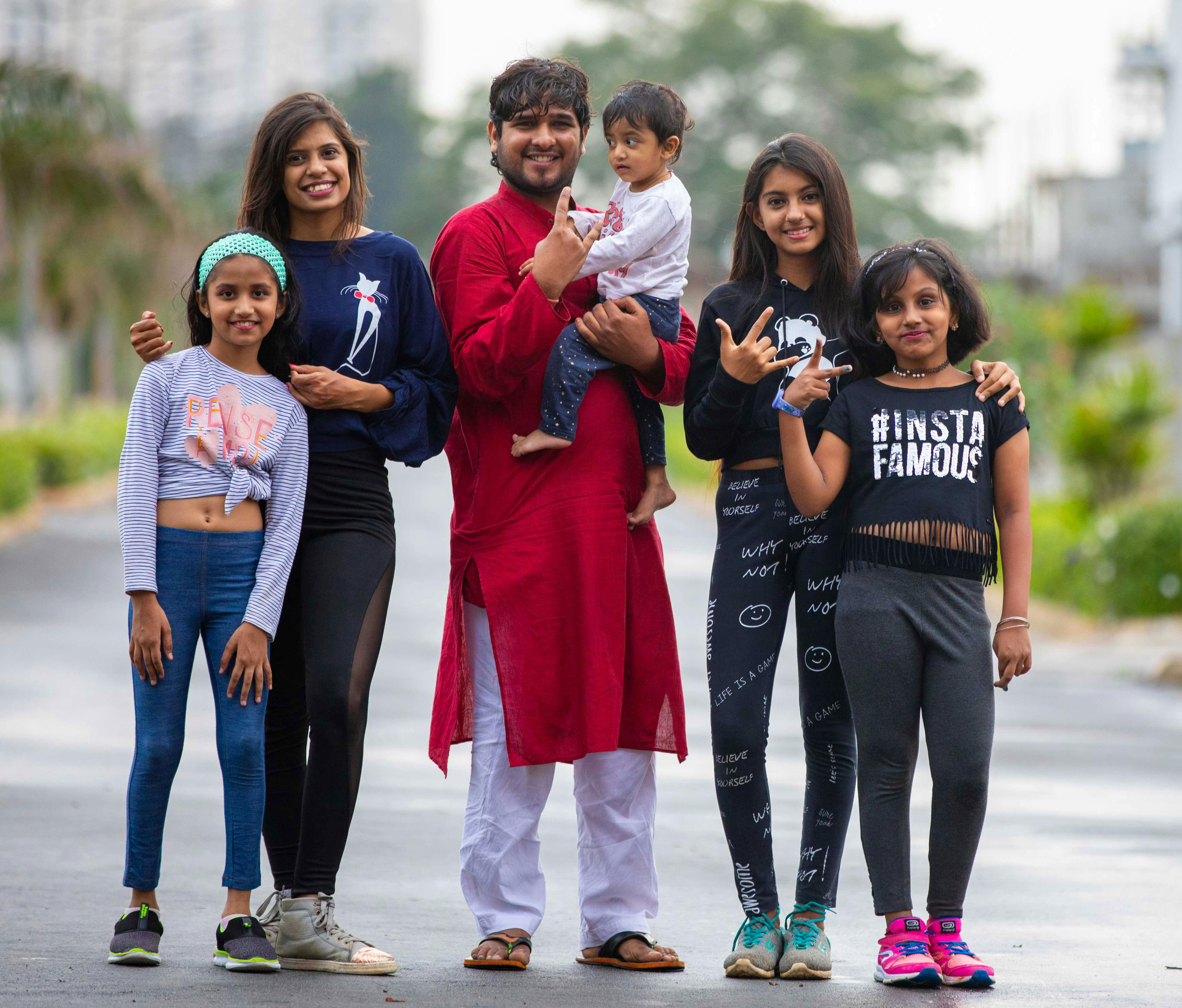 Group of smiling young people including kids posing outdoors Group of smiling young people including kids posing outdoors