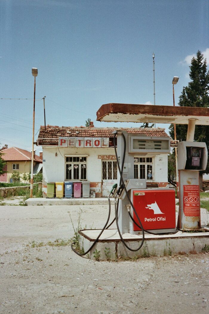Abandoned petrol station with old fuel pumps and rustic building