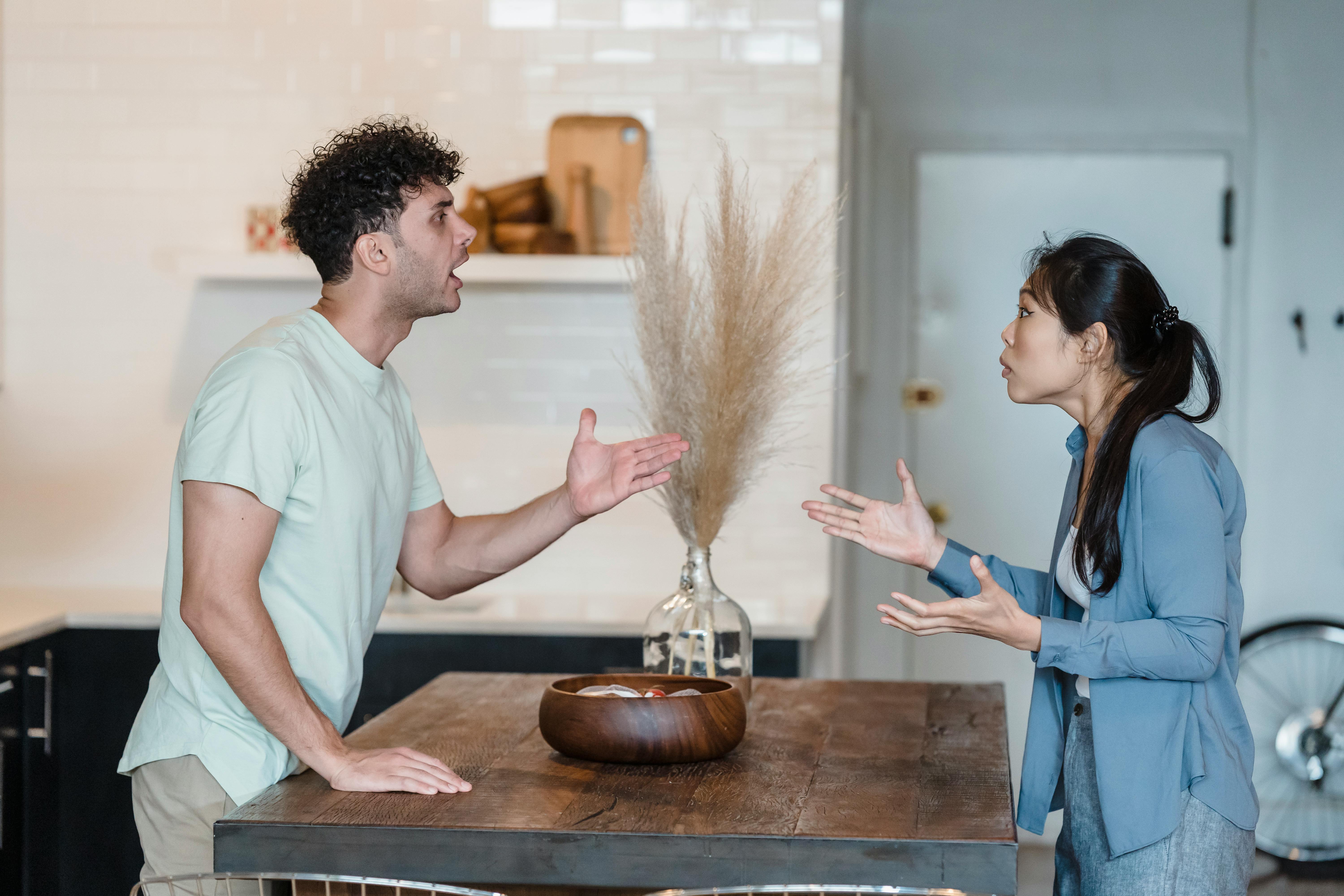 Couple arguing intensely inside their home about fiance and debt issues