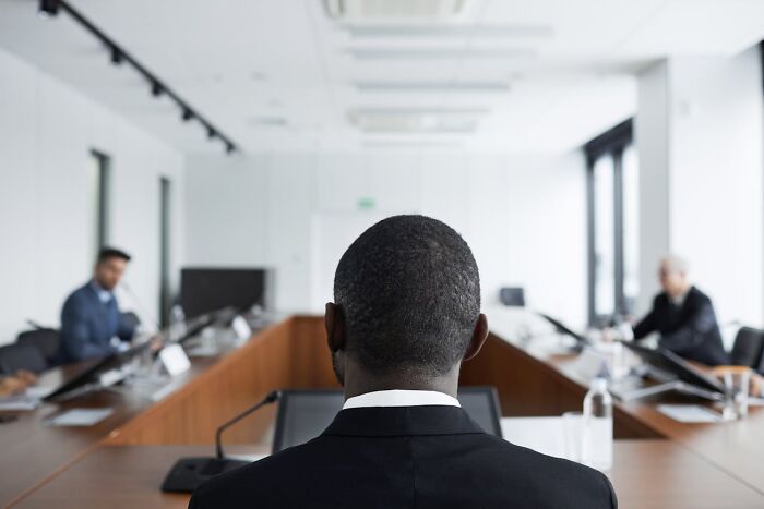 Back view of man in courtroom during legal proceeding