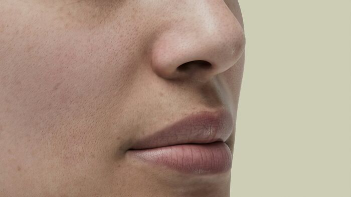 Close-up of a person's nose and lips, showing skin texture. Cool science facts related to human skin and biology.