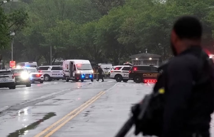 Police secure crime scene after violent incident with multiple patrol vehicles