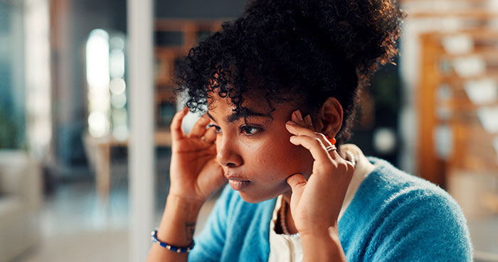 Worried woman contemplating family and childcare struggles