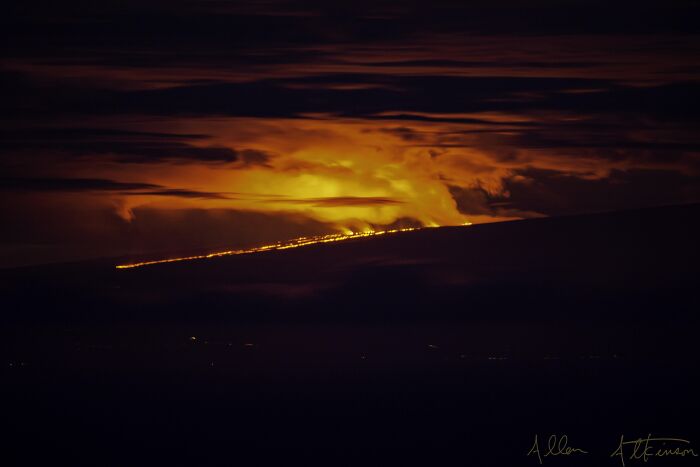 Volcanic eruption with glowing lava under a dark dramatic sky