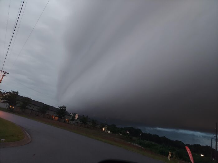Rare moments photo of massive storm cloud over suburban neighborhood