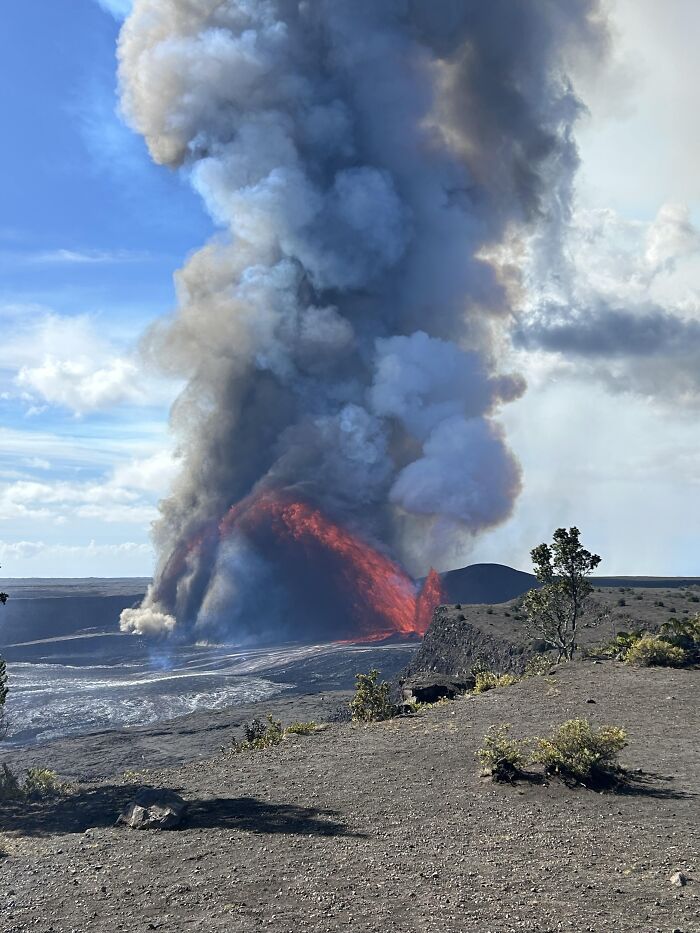 Dramatic volcanic eruption with lava and ash plume in rare moment