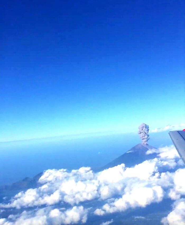 Volcanic eruption viewed from airplane window as rare moments photo