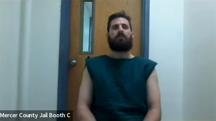 Former Princeton student in Mercer County Jail wearing green detention uniform Former Princeton student in Mercer County Jail wearing green detention uniform