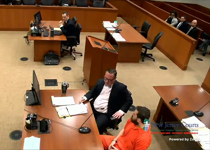 Courtroom hearing with former Princeton student in orange jumpsuit and lawyer Courtroom hearing with former Princeton student in orange jumpsuit and lawyer