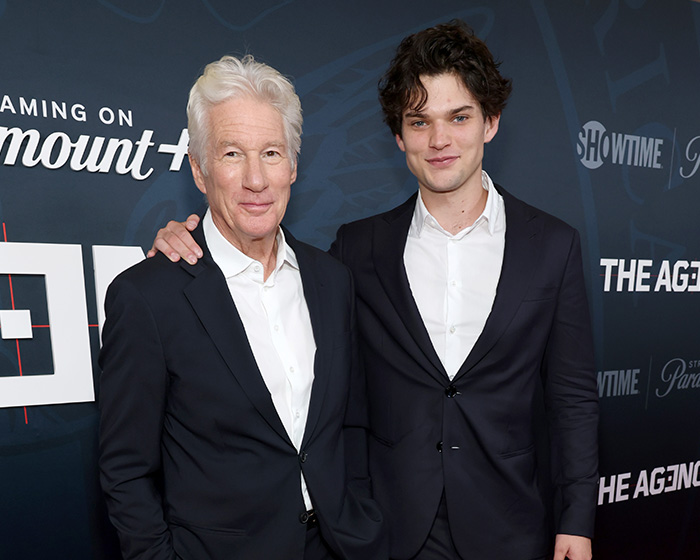 Homer Gere with another man at a premiere event in formal suits Homer Gere with another man at a premiere event in formal suits