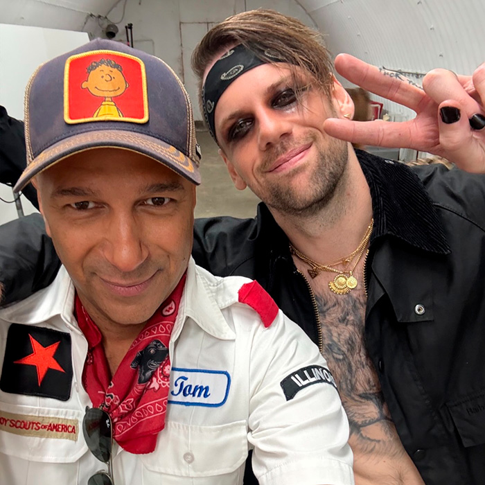 Rockstar posing for selfie with friend wearing distinct bandana and jewelry Rockstar posing for selfie with friend wearing distinct bandana and jewelry