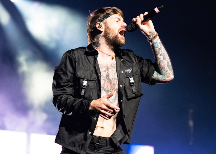 Rockstar performing on stage with intense emotion wearing black outfit and headband Rockstar performing on stage with intense emotion wearing black outfit and headband