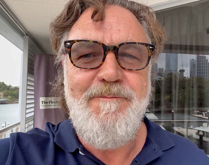 Close-up selfie of Russell Crowe with glasses and beard in relaxed setting