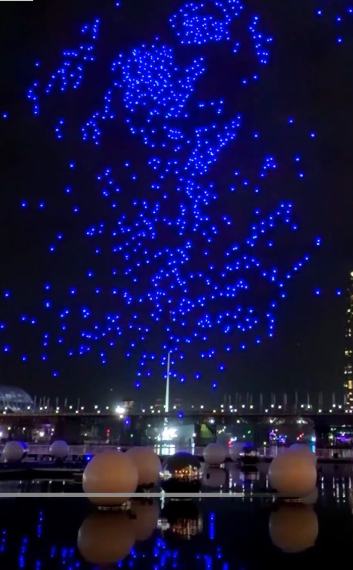 Blue illuminated drones forming patterns during Sydney drone show Blue illuminated drones forming patterns during Sydney drone show