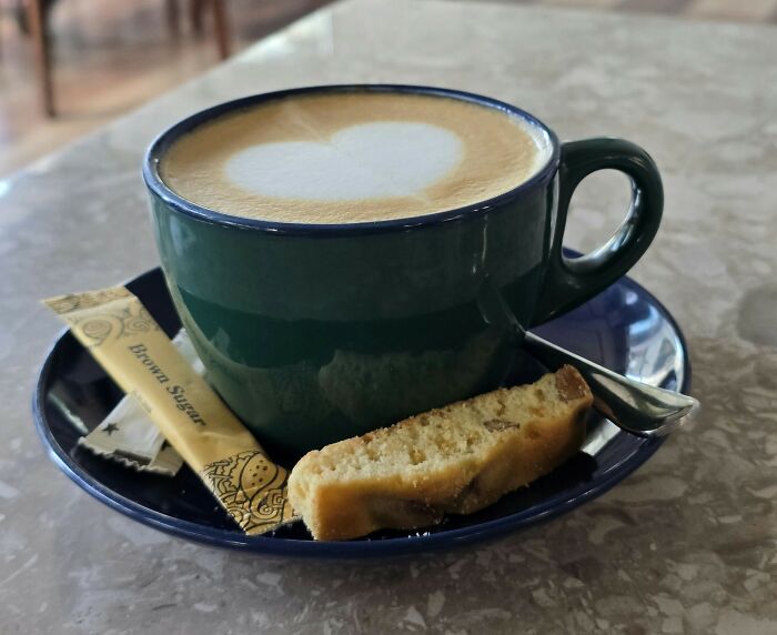 Cup of coffee with biscotti and sugar packet capturing brain on auto pilot scene