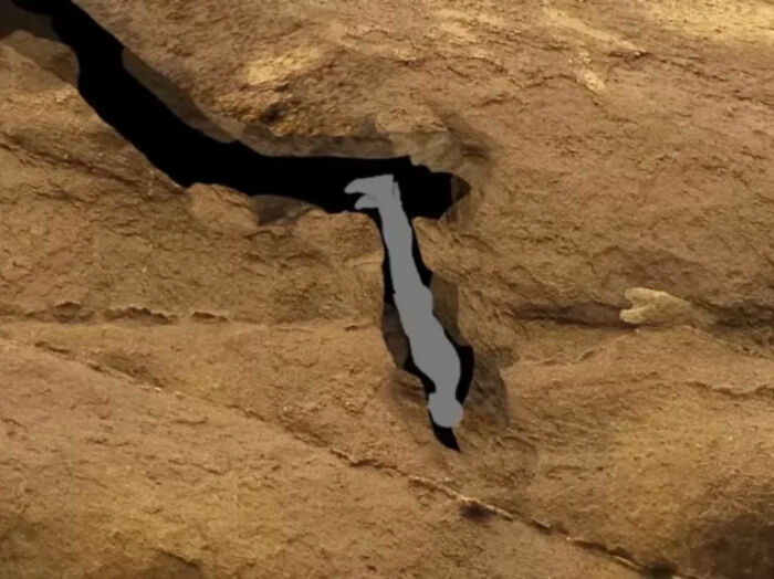 Illustration of a person trapped in a narrow cave crevice
