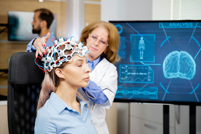 Scientist fitting brain scan electrodes for cognitive research Scientist fitting brain scan electrodes for cognitive research