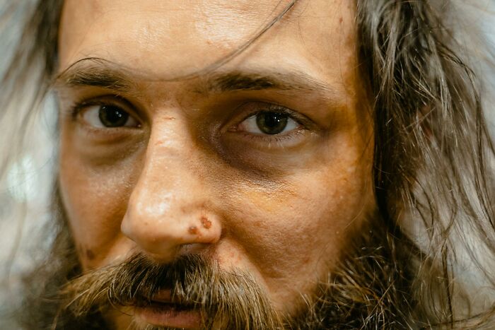 A man with a serious expression and a long beard, his eyes fixed forward. Exploring outdated facts.