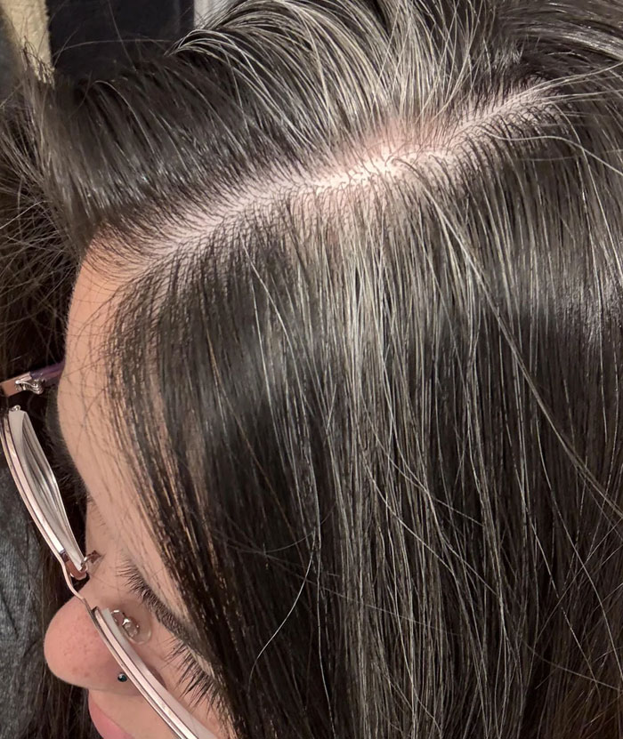 Close-up of scalp showing natural hair with grey strands beauty focus