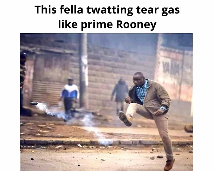 A man kicks a tear gas canister, resembling a football kick. British memes often feature unexpected humor.