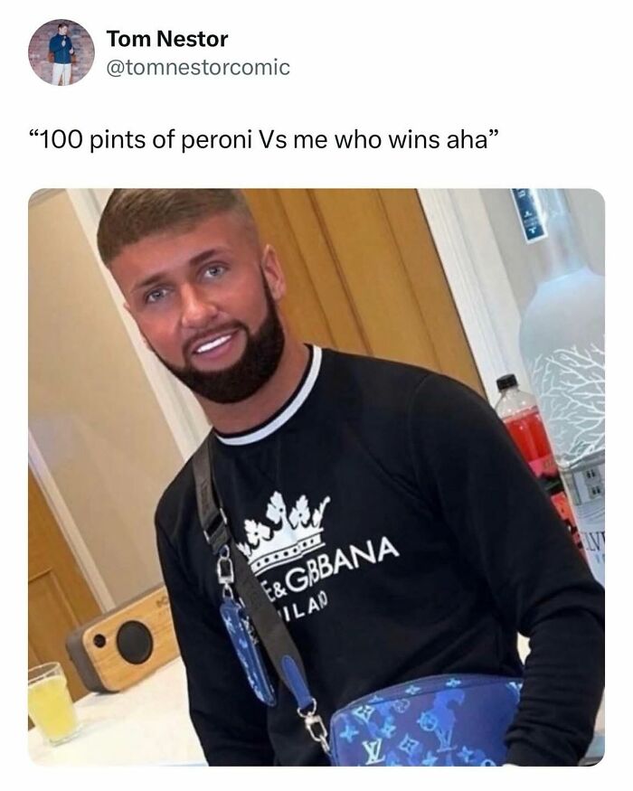 A British man with a fresh haircut and beard, wearing a black sweatshirt and shoulder bag, from a collection of British memes.
