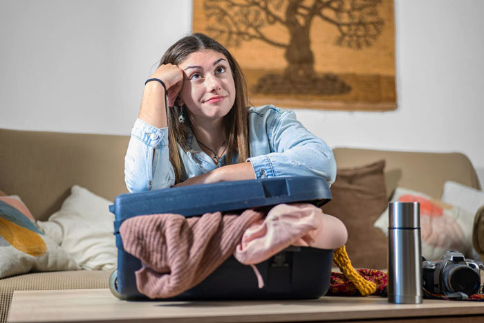 Pregnant woman packing suitcase refusing stressful family vacation Pregnant woman packing suitcase refusing stressful family vacation