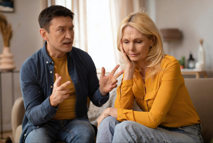 Couple having serious discussion about family vacation and pregnancy stress Couple having serious discussion about family vacation and pregnancy stress