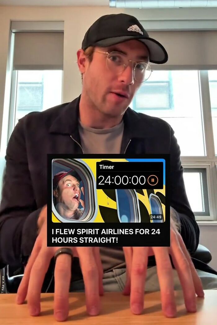 Man in glasses and a hat shows a video thumbnail about Spirit Airlines, featuring a man looking distressed.