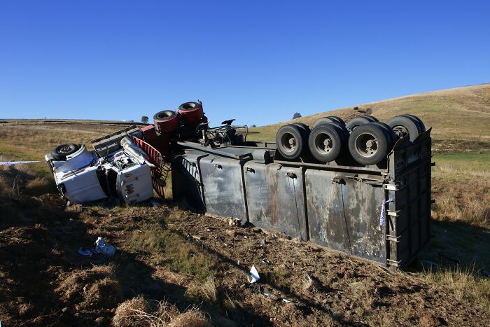 Overturned semi-truck on roadside after accident on a frightening trucking route