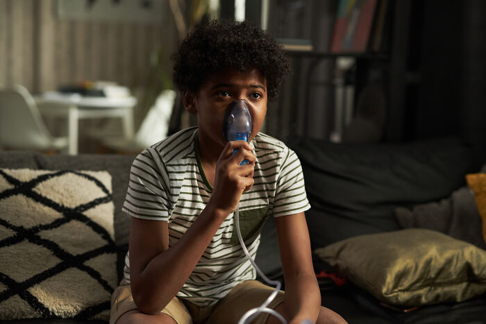 Boy using breathing therapy mask coping after escaping a cult