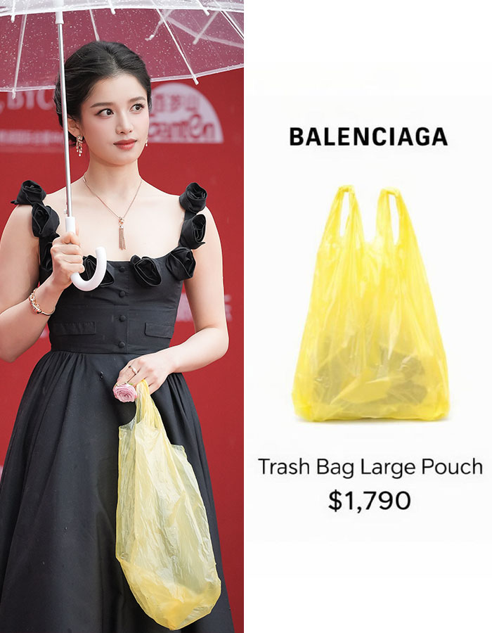A woman holding a Balenciaga Trash Bag Large Pouch, showcasing bizarre fashion trends of 2026.
