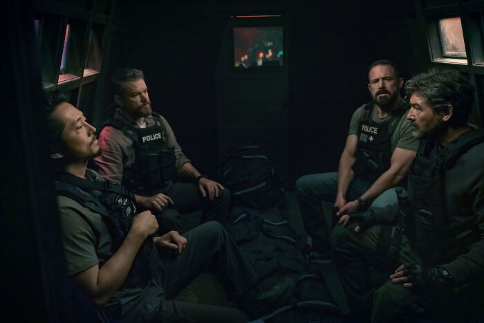 Four men in police vests, including Ben Affleck, in a dark, confined space. Miami Police news. Four men in police vests, including Ben Affleck, in a dark, confined space. Miami Police news.