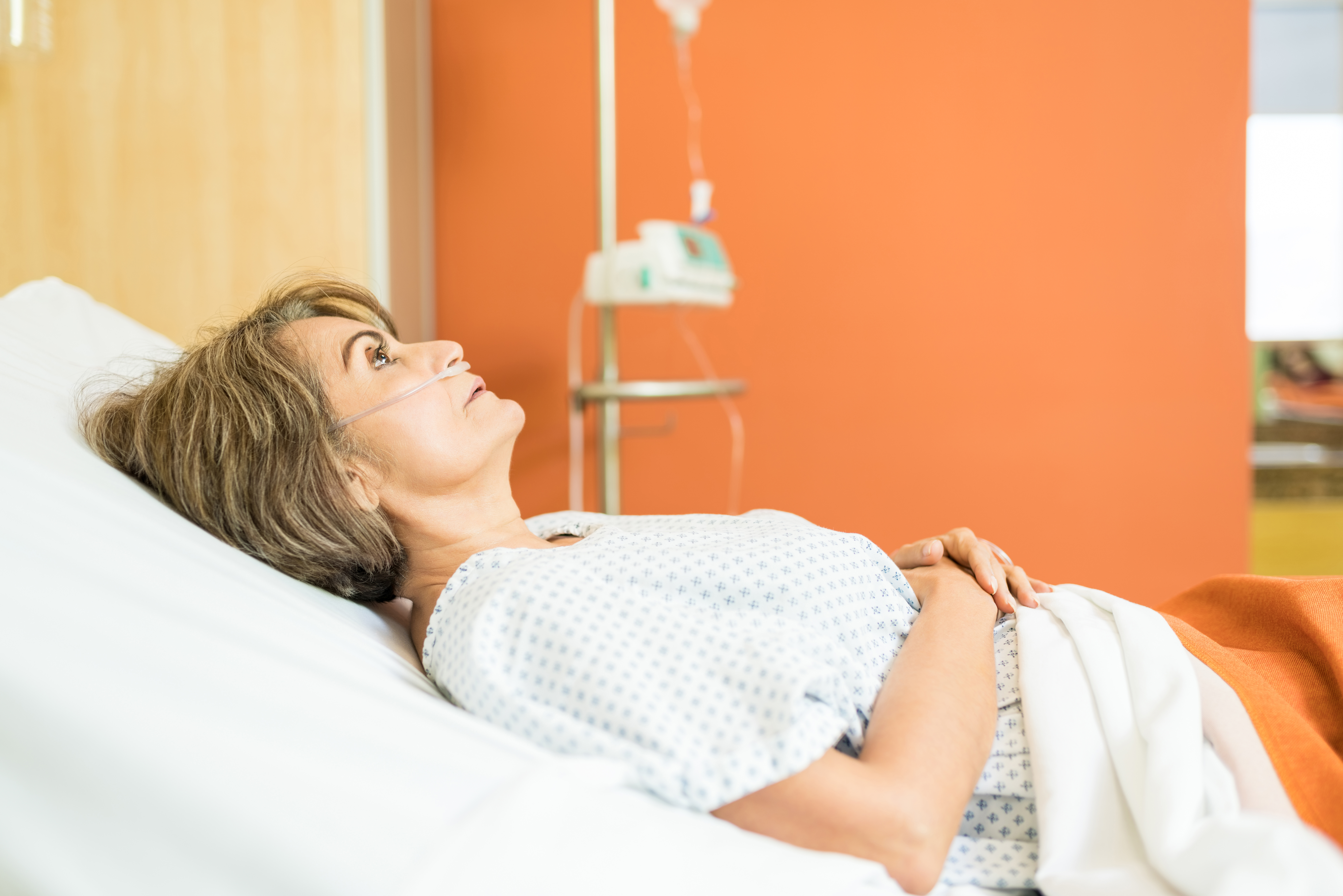 Hospitalized woman with oxygen tube reflecting MIL's mental health crisis