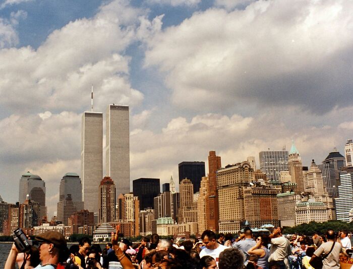 Crowd gathered with city skyline and twin towers in background