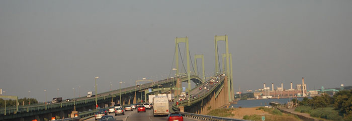 A multi-lane suspension bridge with heavy traffic, showcasing a busy infrastructure in the US States.
