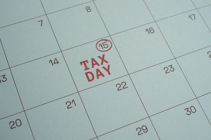 Calendar with tax day marked on 15th in red for tax day reminder