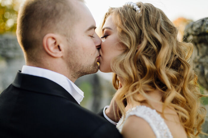 Bride and groom sharing a romantic kiss at wedding ceremony