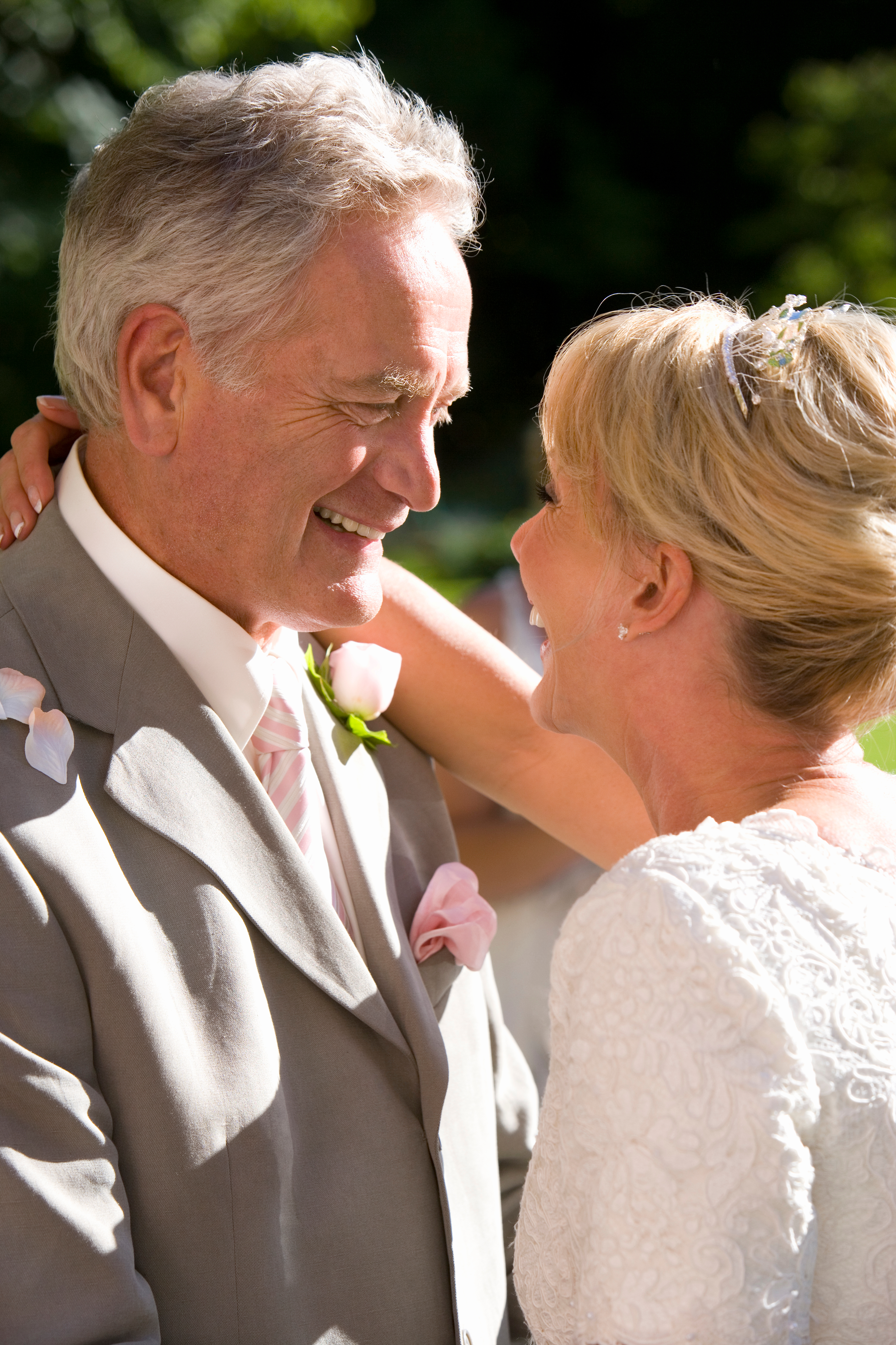 Happy bride and groom dancing at outdoor wedding celebration