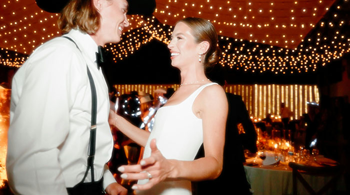 A happy bride in a white dress and groom smiling at a wedding, celebrating a marriage moment.