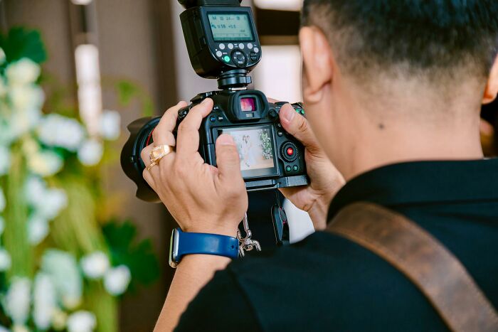 Photographer capturing moments with camera at wedding event