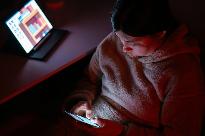 Person preparing digital afterlife using smartphone at night