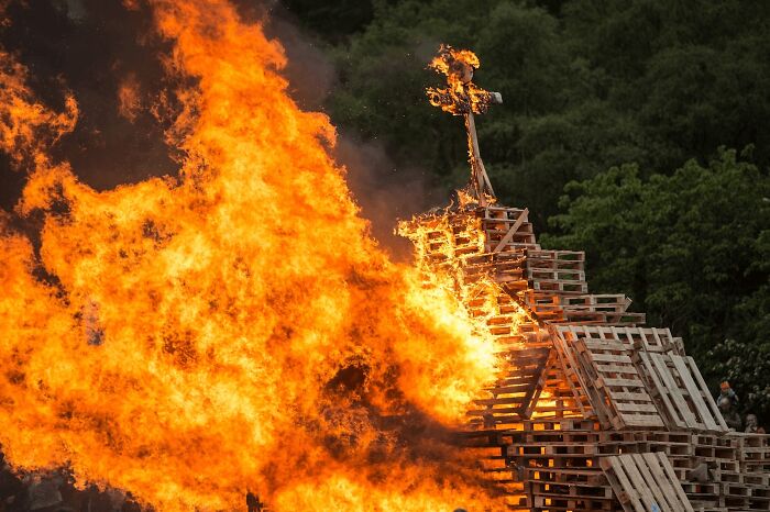 Large bonfire with wooden pallets burning during a local festival