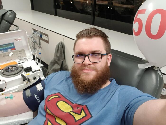 Man with beard donating blood in compassionate health and wellness act