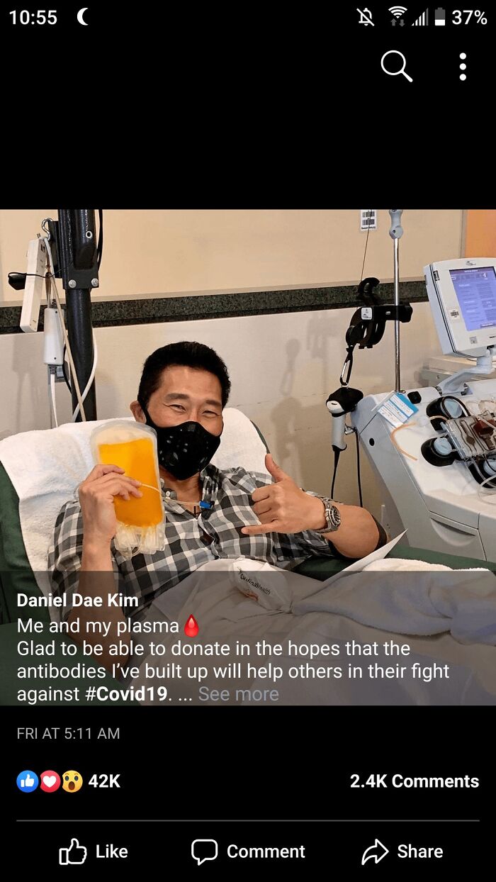 Man donating COVID-19 plasma at medical center showing thumbs up